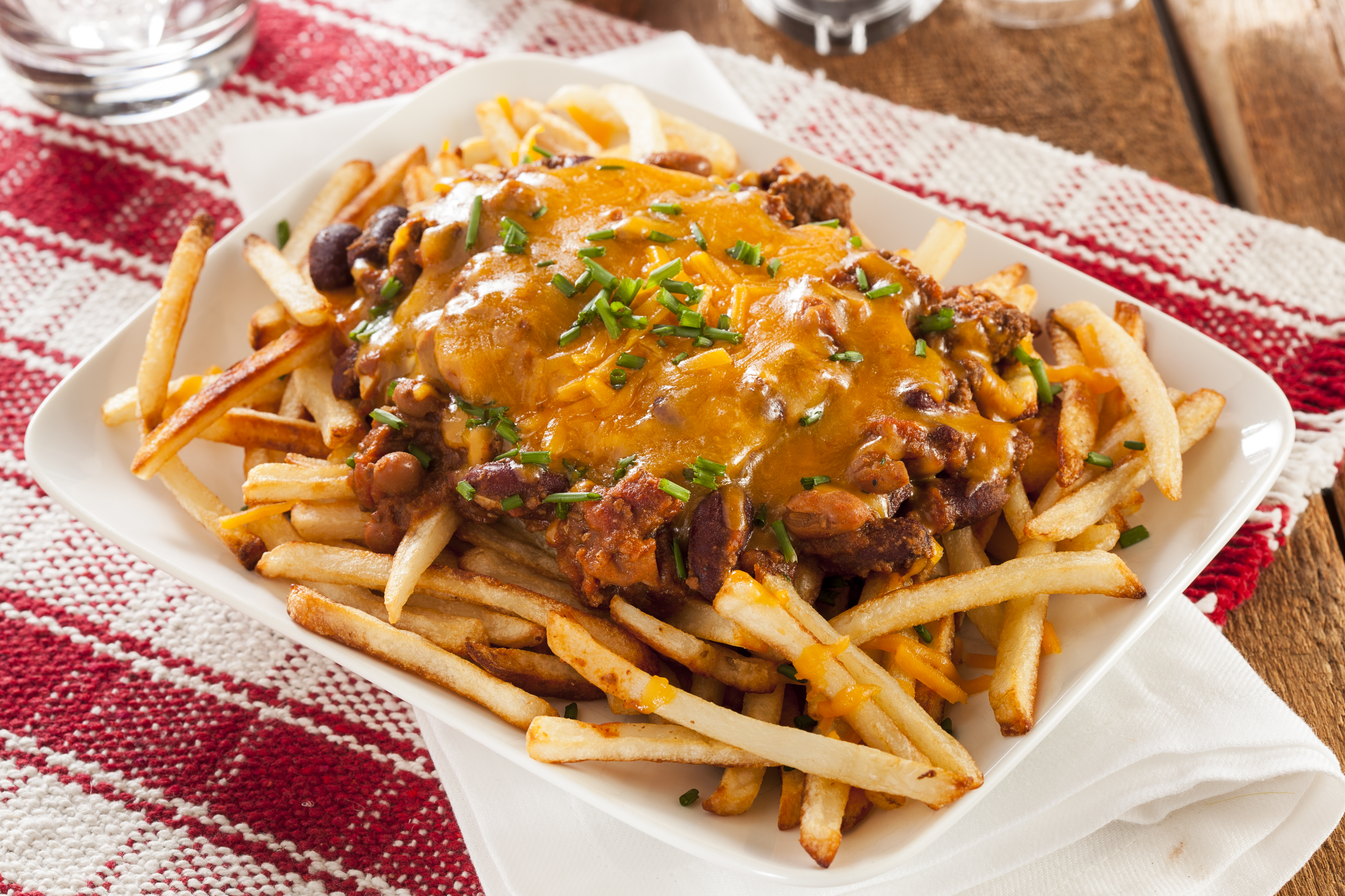 Unhealthy Messy Chili Cheese Fries on a Background