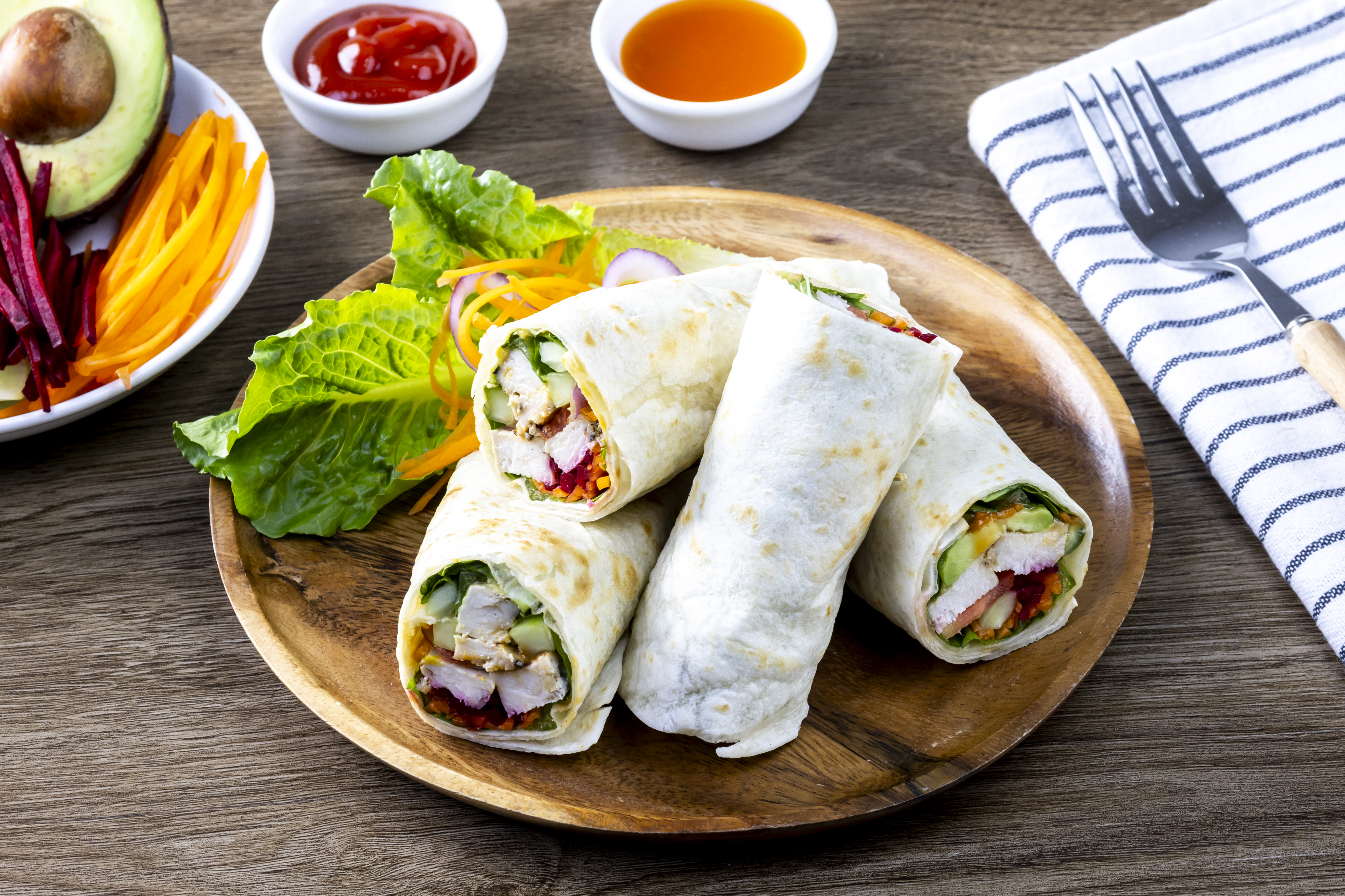 Chicken breast with caesar dressing and lettuce in a gluten-free tortilla wrap, tasty food